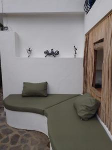a room with a green couch in the corner at NEW MORINGA in Las Terrenas