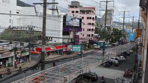 a busy city street with a lot of buildings and cars at Patong Triple P in Patong Beach
