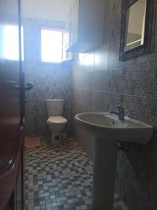 a bathroom with a sink and a toilet at appartamenti Oueslati in Houmt Souk
