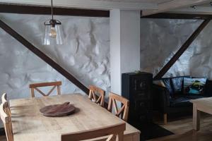 a dining room with a wooden table and chairs at Cozy cottage in Klaksvík