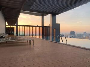 a building with a deck with benches on the roof at The View Serviced Residence 豪景日式酒店公寓 in Phnom Penh