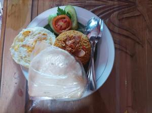 un plato de comida con huevos y verduras en una mesa en Shoreside Semat Villa and Flat en Jepara