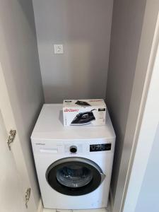 a washing machine with a box on top of it at Apartment in Başakşehir 450 meters far from metro station in Istanbul