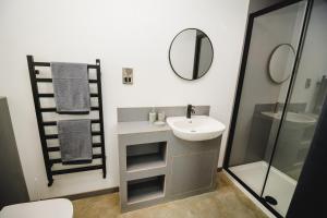 a bathroom with a sink and a shower and a mirror at Sandy Barn *BRAND NEW* Barn Conversion in Tunstead +22 photos