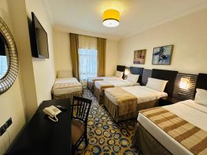 Postel nebo postele na pokoji v ubytování Saif Al Majd Hotel