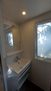 a bathroom with a sink and a window at Camping Bella Vista in Ceriale