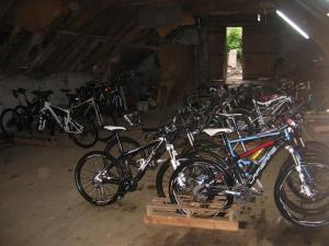 - un groupe de vélos garés dans un garage dans l'établissement Logis Hotels - Hôtel - Restaurant - Bar - Le Sapin Fleuri, à Bourg-dʼOueil