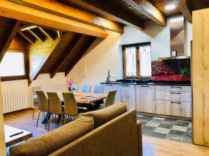 a kitchen and dining room with a table and chairs at Apartamentos Zabalarena Basoa in Orbaiceta
