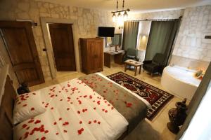 a bedroom with a bed with red flowers on it at Castle Panorama House in Nevşehir