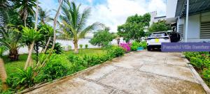 a car parked next to a house with a driveway at Peaceful Villa Seaview - From The Beach 400m in Phan Thiet
