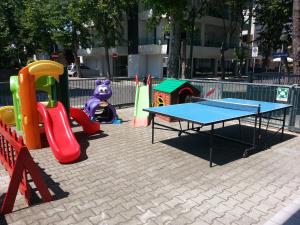 a play area with a ping pong table and a ping at Hotel La Parigina in Cesenatico