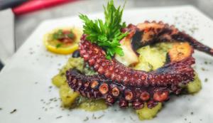 a plate of food with a seafood dish on it at Apartments Val in Dobra Voda