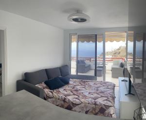 a bedroom with a bed and a view of the ocean at Inagua Sol apartment in Puerto Rico de Gran Canaria +28 photos