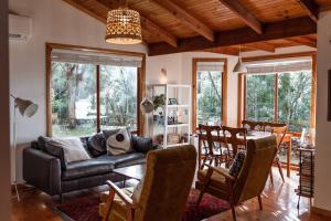 a living room with a couch and a table at Birdsong in Adventure Bay