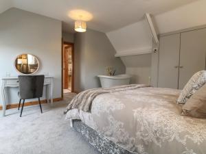 a bedroom with a bed and a desk and a mirror at Old Print House in Ilkeston