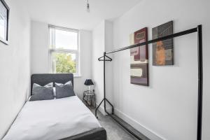a bedroom with a bed and some pictures on the wall at Luxurious 2 Bedroom Apartment with Free Parking in Chelmsford City Centre with Sky Sports & Movies in Chelmsford +21 photos
