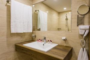 a bathroom with a sink and a mirror at Grand Hotel Sunny Beach - All Inclusive in Sunny Beach