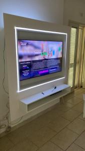 a large flat screen tv on a wall at CASA DIVINO in Bari