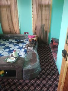 a bedroom with a bed with a tray of food on it at Chand Tara paying Guest house in Srinagar