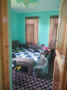 two beds in a room with blue walls at Chand Tara paying Guest house in Srinagar