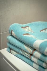 a pile of towels sitting on top of a shelf at Yacht Apartments in Wilkasy