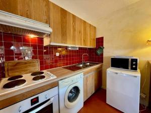 a kitchen with a washing machine and a sink at Appartement Quiberon, 3 pièces, 5 personnes - FR-1-478-75 in Quiberon