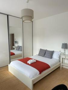 a bedroom with a large white bed with a mirror at Luxury Apartments London Eye, Westminster, Big Ben, Borough Market in London