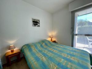 - une chambre avec un lit et une fenêtre avec une chaise dans l'établissement Studio Quiberon, 1 pièce, 2 personnes - FR-1-478-179, à Quiberon