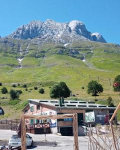 a train station with a mountain in the background at La Tana del Capriolo in Prati di Tivo