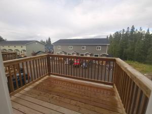 a wooden deck with a railing on a house at Comfort First - sleeps 6 in Whitehorse