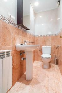 a bathroom with a sink and a toilet at Apartamento con garaje in Luanco