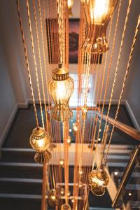 a bunch of gold lights hanging from a ceiling at Saint Pauls House in Birmingham