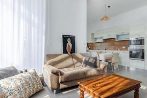 a living room with a couch and a coffee table at Bright Apartment minutes from the Sea in Il-Gżira