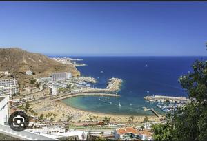 a view of a beach and the ocean at Apartment Montaña Clara & pool in Mogán