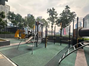 a playground in a city with swings at Anggun Residence KL by F&F in Kuala Lumpur