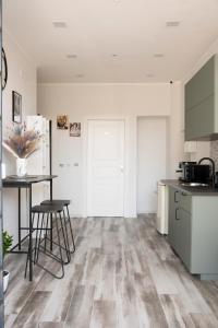 a kitchen with wooden floors and a table and chairs at Fara's House in Naples +26 photos