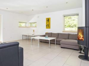 uma sala de estar com um sofá e uma lareira em 14 person holiday home in Grenaa em Grenå
