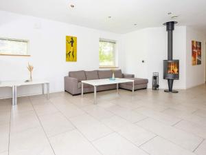 a living room with a couch and a fireplace at 14 person holiday home in Grenaa in Grenå