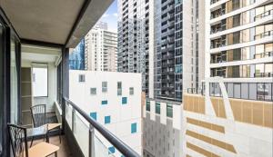 a balcony with a view of some tall buildings at ReadySet Apartments on Kavanagh in Melbourne