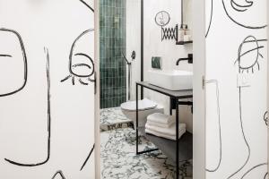 a bathroom with a sink and a toilet at Aries' Collection Luxury Suites in Braşov +32 photos