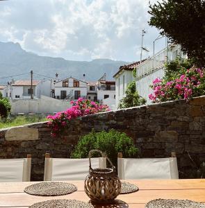 a table with chairs and a basket on top of it at Keepos by Polykratis in Kokkari