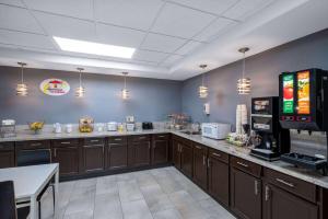 a kitchen with a counter with a soda machine at Super 8 by Wyndham Salisbury in Salisbury