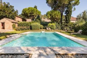 a swimming pool in the yard of a house at Agriturismo Tenuta Castel Venezze in San Martino di Venezze