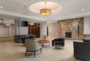 a lobby with couches and chairs and a fireplace at DoubleTree by Hilton Pittsburgh Airport in Moon Township