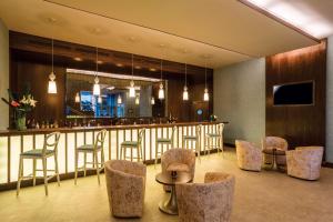 a bar in a restaurant with chairs and a counter at Hilton Garden Inn Tanger City Centre in Tangier