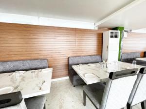 a dining room with two tables and chairs at Hotel TBS sea view ! Puri Swimming-pool, fully-air-conditioned-hotel with-lift-and-parking-facility breakfast-included in Puri