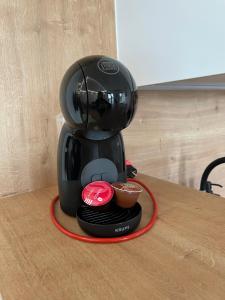 a coffee maker on a counter with a cup of coffee at Apartmán Plešivec ALL4FUN u sjezdovky in Abertamy