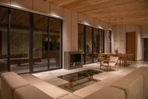 a living room with a couch and a table at SOOTHE FOREST in Shio