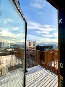 a balcony with a view of a city at TotalApartments Vervet Gjøa, brand new apartments in Tromsø
