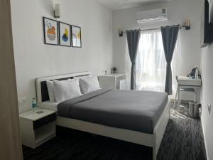 a hotel room with a bed and a window at U by Z Hotels, Bellandur in Bangalore